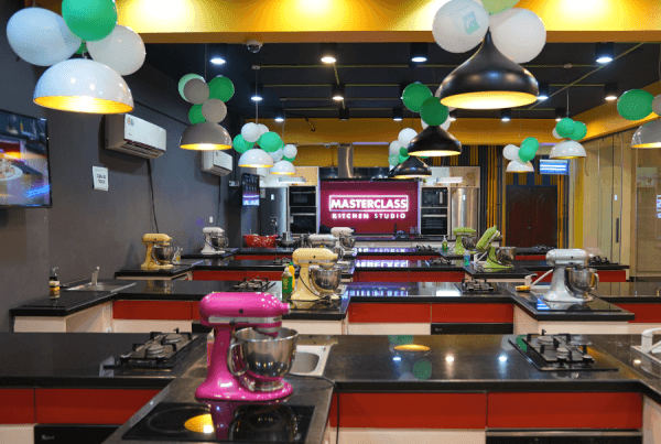 Professional kitchen setup with students cooking and learning